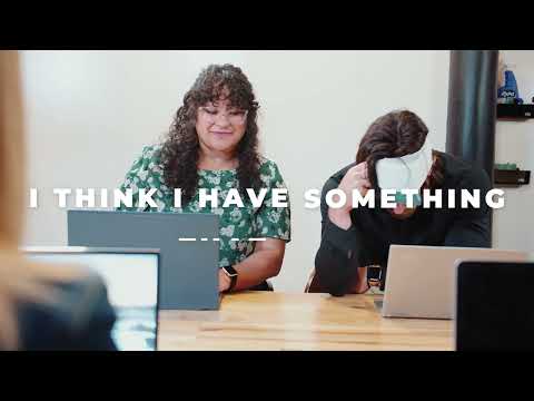 A woman smiling while wearing a HurtSkurt migraine headband for migraine pain relief video.