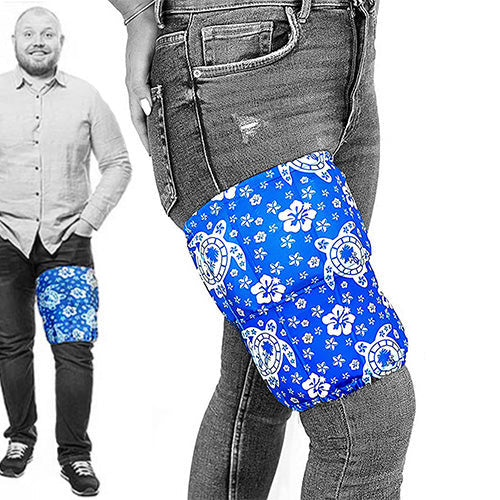 A man wearing a blue tropical patterned extra large ice pack with flower and sea turtle designs around his thigh for pain relief.