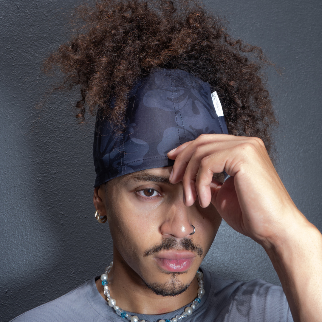 A woman styling her hair while wearing a HurtSkurt ice pack headband.